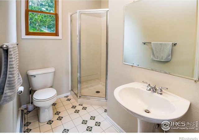 full bathroom with a sink, a stall shower, toilet, and tile patterned flooring
