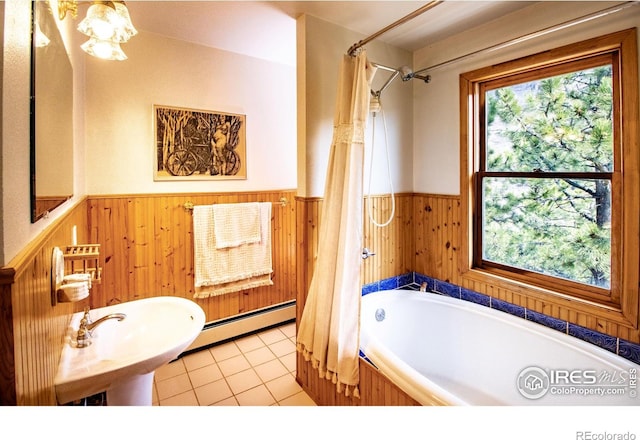 full bath featuring a baseboard heating unit, wainscoting, a bathtub, tile patterned floors, and a shower with curtain