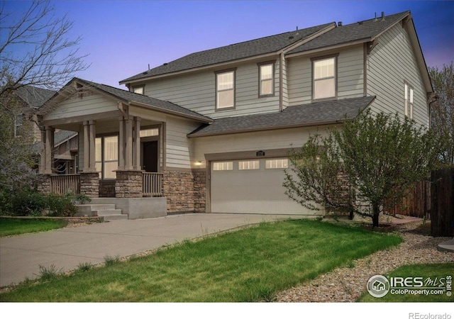 view of front of home featuring an attached garage, concrete driveway, and a porch