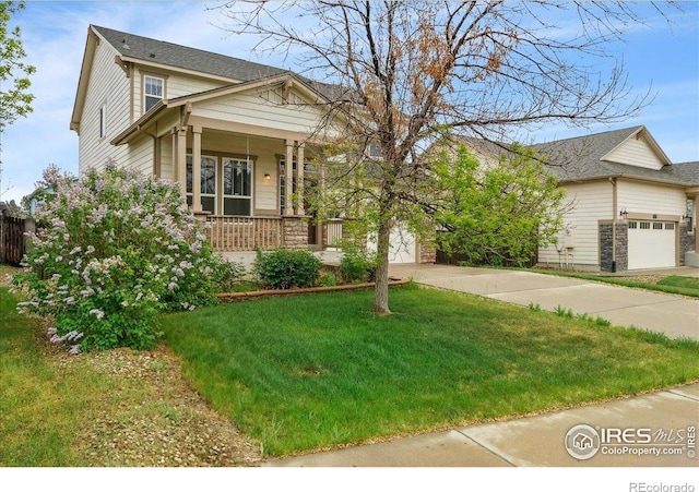 view of front of home featuring driveway, a porch, a garage, and a front lawn