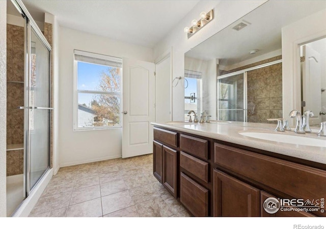 full bath with a sink and a shower stall