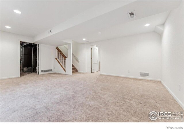 finished basement featuring visible vents and recessed lighting