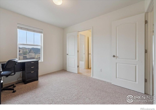 home office with carpet floors and baseboards