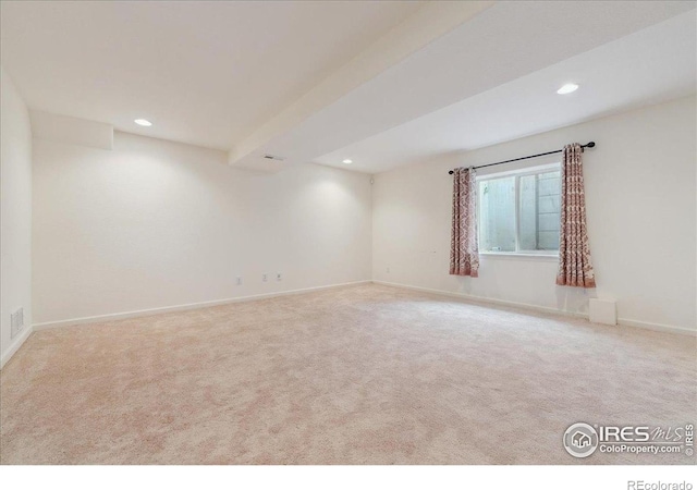 spare room featuring carpet, recessed lighting, and baseboards