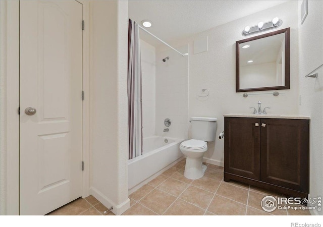 bathroom featuring tile patterned flooring, toilet, vanity, shower / bath combination with curtain, and baseboards