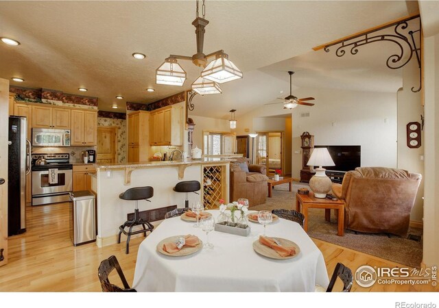 dining space featuring recessed lighting, light wood finished floors, ceiling fan, and vaulted ceiling