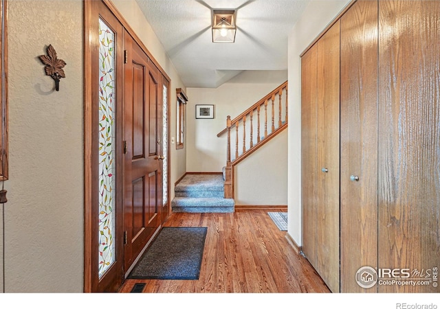 2819 Seccomb St, Fort Collins, CO 80526 - entrance foyer featuring wood finished floors and stairs