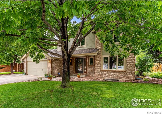 2819 Seccomb St, Fort Collins, CO 80526 - view of front facade with a front yard, brick siding, concrete driveway, and a garage
