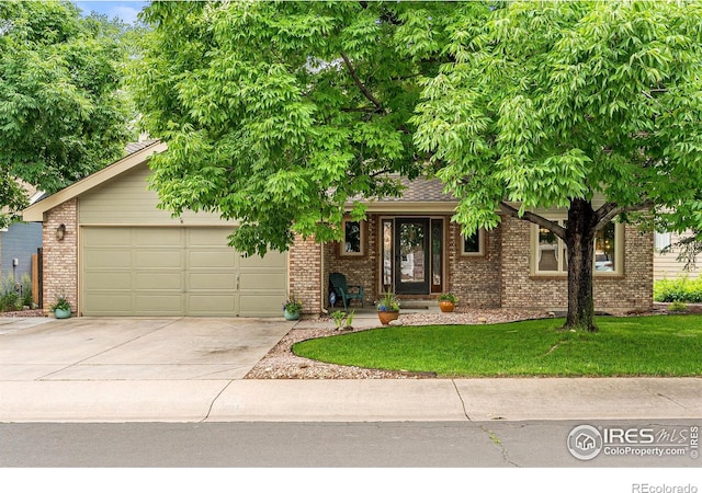 2819 Seccomb St, Fort Collins, CO 80526 - view of front of home with driveway, brick siding, a front yard, and an attached garage