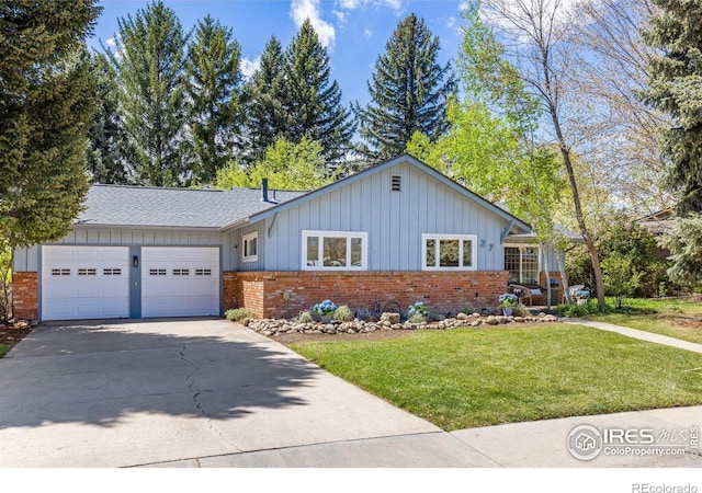 ranch-style house featuring brick siding, concrete driveway, a garage, a front lawn, and board and batten siding