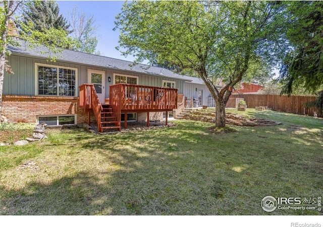 back of property featuring board and batten siding, stairway, a deck, and fence