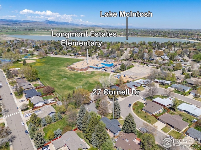 drone / aerial view featuring a water view and a residential view