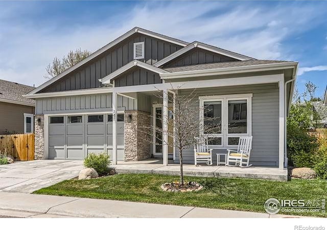 craftsman house featuring an attached garage, fence, concrete driveway, board and batten siding, and a porch