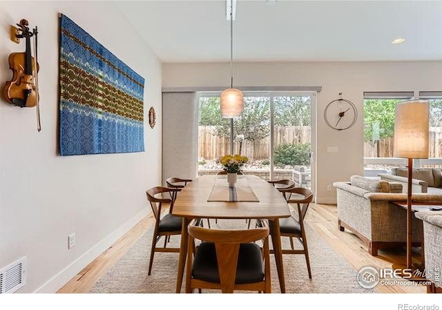 dining area featuring a wealth of natural light, baseboards, visible vents, and light wood-style floors