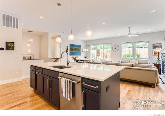 kitchen with a sink, light wood-type flooring, visible vents, ceiling fan, and dishwasher