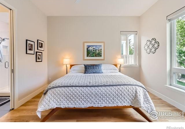 bedroom with light wood-style flooring and baseboards