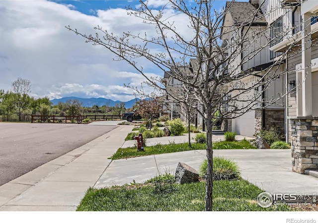 view of road with a mountain view and sidewalks