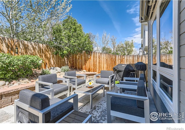view of patio / terrace featuring a grill, a fenced backyard, and an outdoor living space