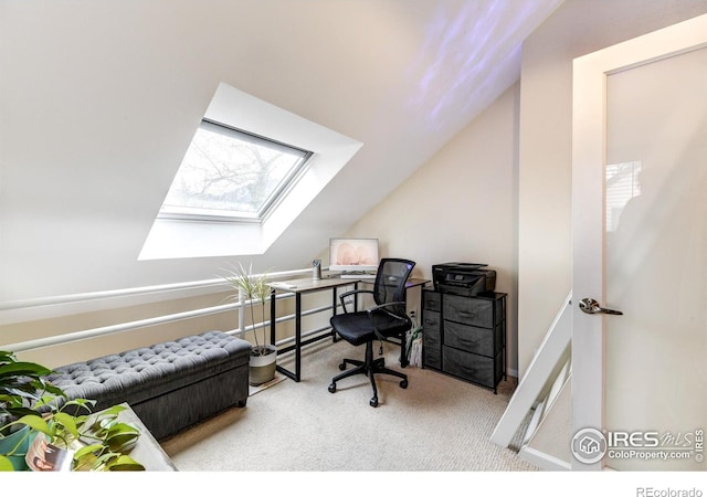 carpeted home office with lofted ceiling with skylight