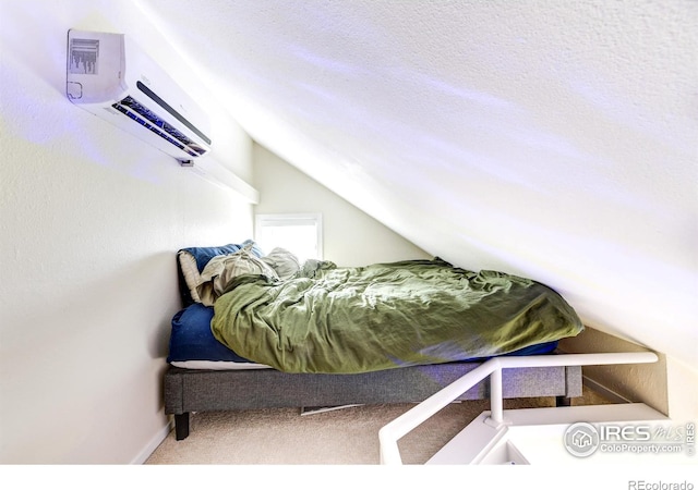 bedroom featuring baseboards, carpet flooring, a wall mounted AC, and vaulted ceiling