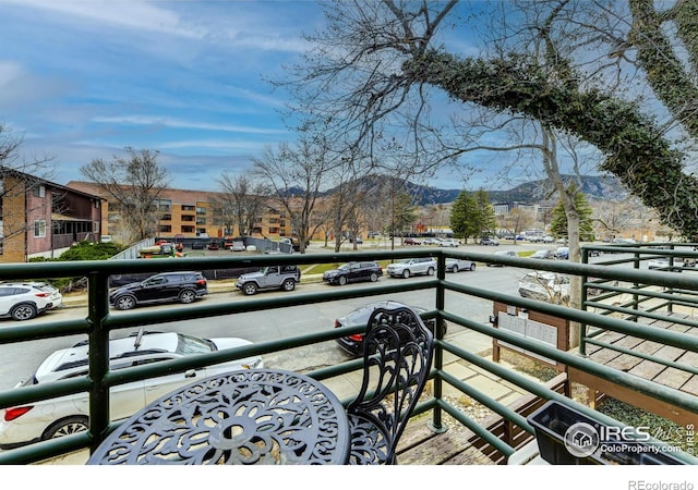 balcony featuring a mountain view and an exterior structure