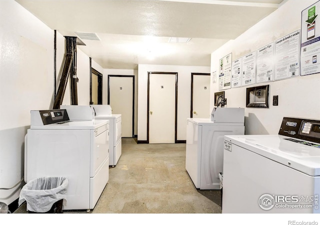 common laundry area with separate washer and dryer and visible vents
