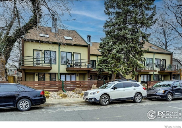 view of front of property featuring a shingled roof and stucco siding