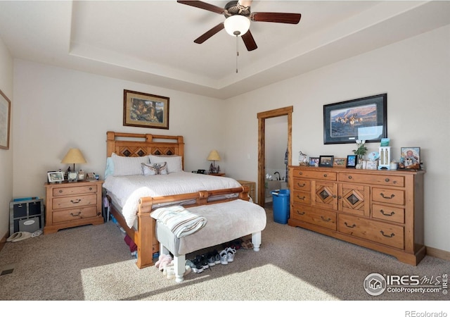 7084 Sumner St, Wellington, CO 80549 - carpeted bedroom featuring a tray ceiling and a ceiling fan