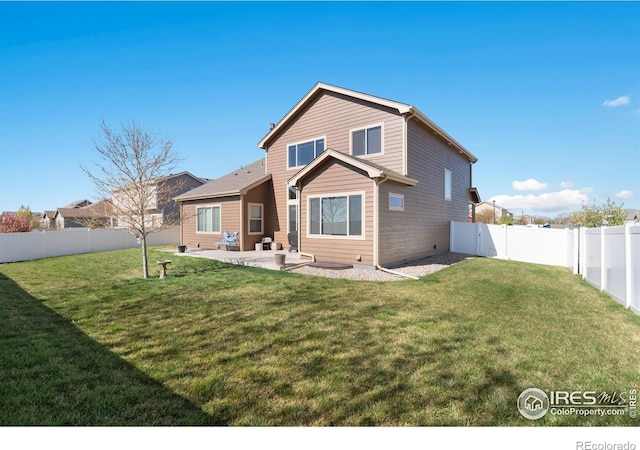 7084 Sumner St, Wellington, CO 80549 - back of property featuring a fenced backyard, a patio, and a lawn