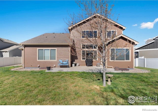 7084 Sumner St, Wellington, CO 80549 - back of property with a lawn, a patio, and a fenced backyard