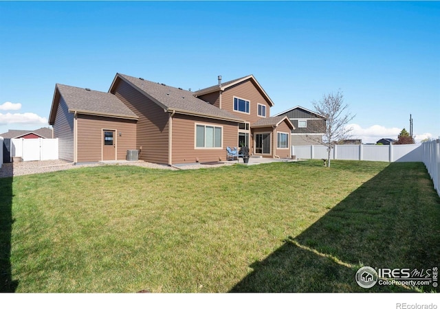 7084 Sumner St, Wellington, CO 80549 - rear view of property featuring a lawn, cooling unit, a patio, and a fenced backyard