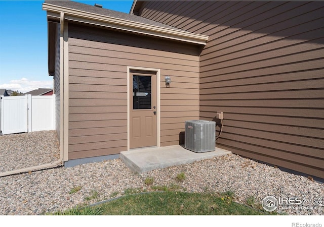 7084 Sumner St, Wellington, CO 80549 - doorway to property with cooling unit and fence