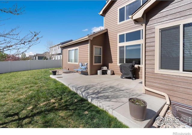 7084 Sumner St, Wellington, CO 80549 - back of house with a patio area, a lawn, and a fenced backyard