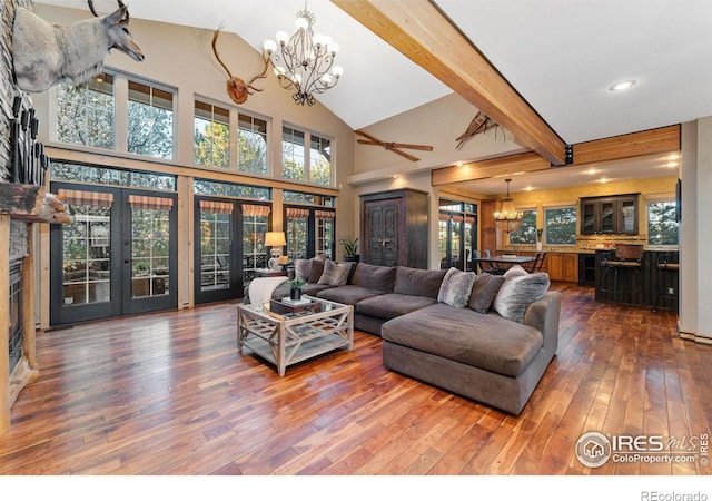 14582 Homestead Pl, Broomfield, CO 80023 - living area featuring a chandelier, french doors, hardwood / wood-style flooring, a high ceiling, and beam ceiling