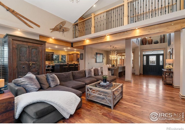 14582 Homestead Pl, Broomfield, CO 80023 - living area with high vaulted ceiling, wood finished floors, and a chandelier