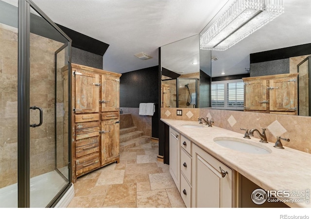 14582 Homestead Pl, Broomfield, CO 80023 - full bathroom with a stall shower, stone tile flooring, double vanity, and tile walls