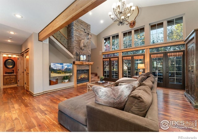 14582 Homestead Pl, Broomfield, CO 80023 - living room with french doors, hardwood / wood-style floors, recessed lighting, a large fireplace, and high vaulted ceiling