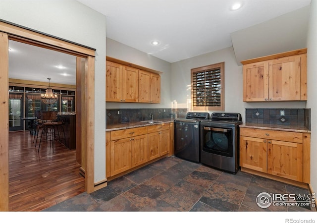 14582 Homestead Pl, Broomfield, CO 80023 - clothes washing area featuring washing machine and clothes dryer, cabinet space, a chandelier, recessed lighting, and dark stone finish floors