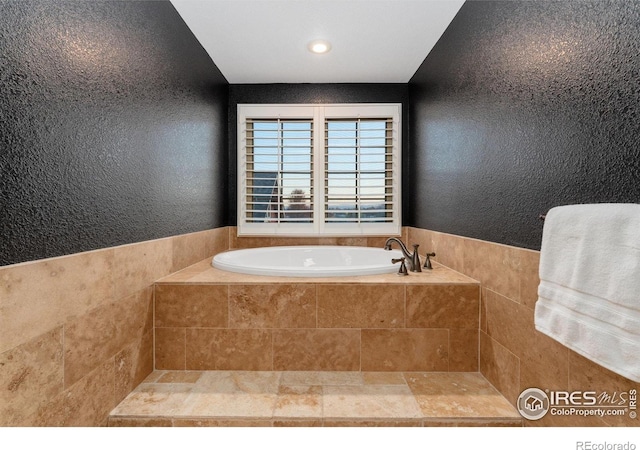 14582 Homestead Pl, Broomfield, CO 80023 - bathroom featuring a bath, a textured wall, and recessed lighting