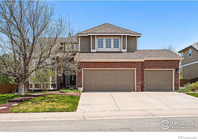 10305 Charissglen Cir, Highlands Ranch, CO 80126 - view of front facade featuring brick siding, roof with shingles, concrete driveway, a garage, and a front lawn