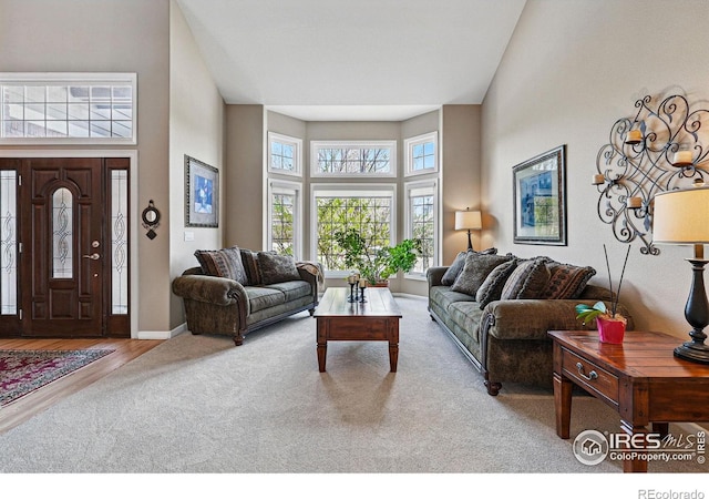 10305 Charissglen Cir, Highlands Ranch, CO 80126 - carpeted living room featuring a towering ceiling and baseboards
