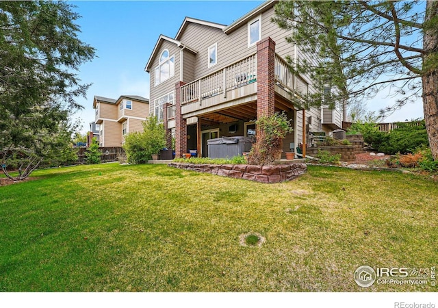 10305 Charissglen Cir, Highlands Ranch, CO 80126 - back of property featuring a hot tub, a wooden deck, and a yard