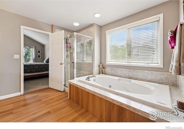 10305 Charissglen Cir, Highlands Ranch, CO 80126 - ensuite bathroom with a stall shower, a tub with jets, wood finished floors, and lofted ceiling
