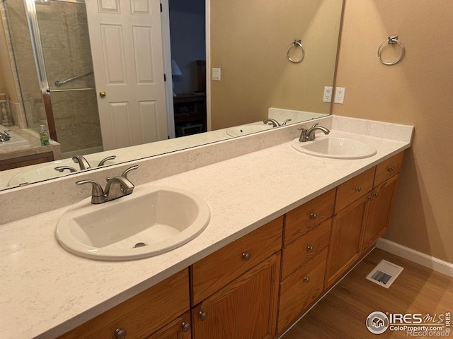 10305 Charissglen Cir, Highlands Ranch, CO 80126 - bathroom featuring double vanity and wood finished floors