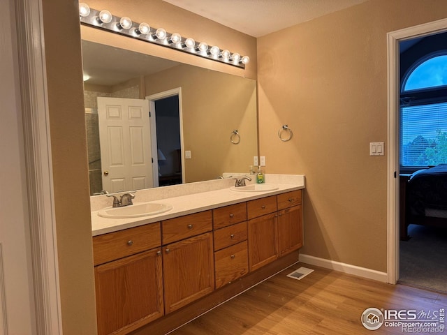 10305 Charissglen Cir, Highlands Ranch, CO 80126 - ensuite bathroom with double vanity and wood finished floors
