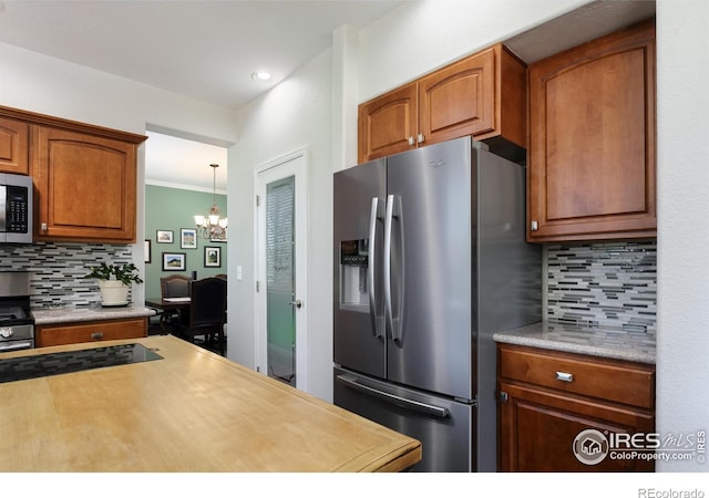 1809 Keel Ct, Lafayette, CO 80026 - kitchen featuring light countertops, stainless steel appliances, a chandelier, and decorative backsplash