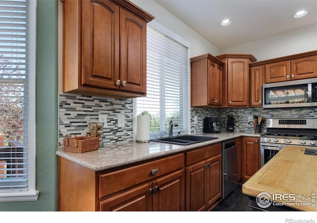 1809 Keel Ct, Lafayette, CO 80026 - kitchen featuring a sink, stainless steel appliances, light countertops, decorative backsplash, and recessed lighting