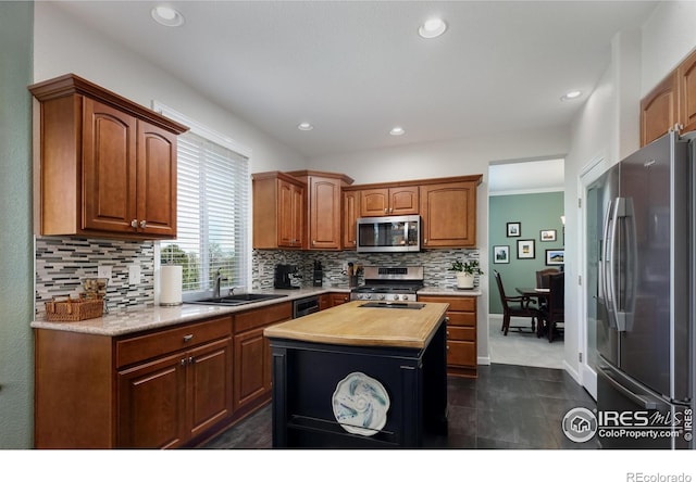 1809 Keel Ct, Lafayette, CO 80026 - kitchen featuring a sink, stainless steel appliances, tasteful backsplash, butcher block counters, and recessed lighting