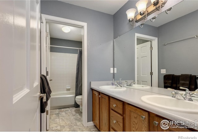 1809 Keel Ct, Lafayette, CO 80026 - bathroom featuring toilet, marble finish floor, double vanity, and a sink