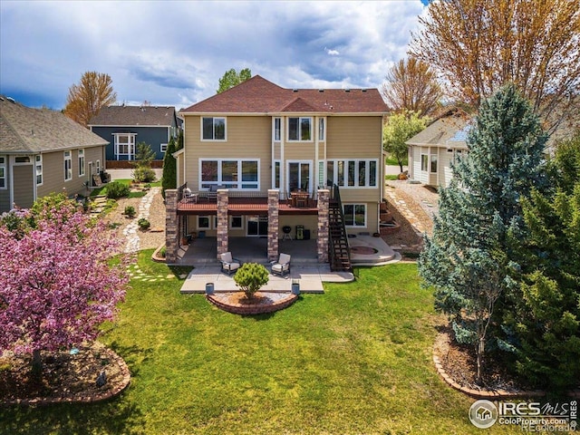 rear view of house with stairs, a patio area, a yard, and a deck